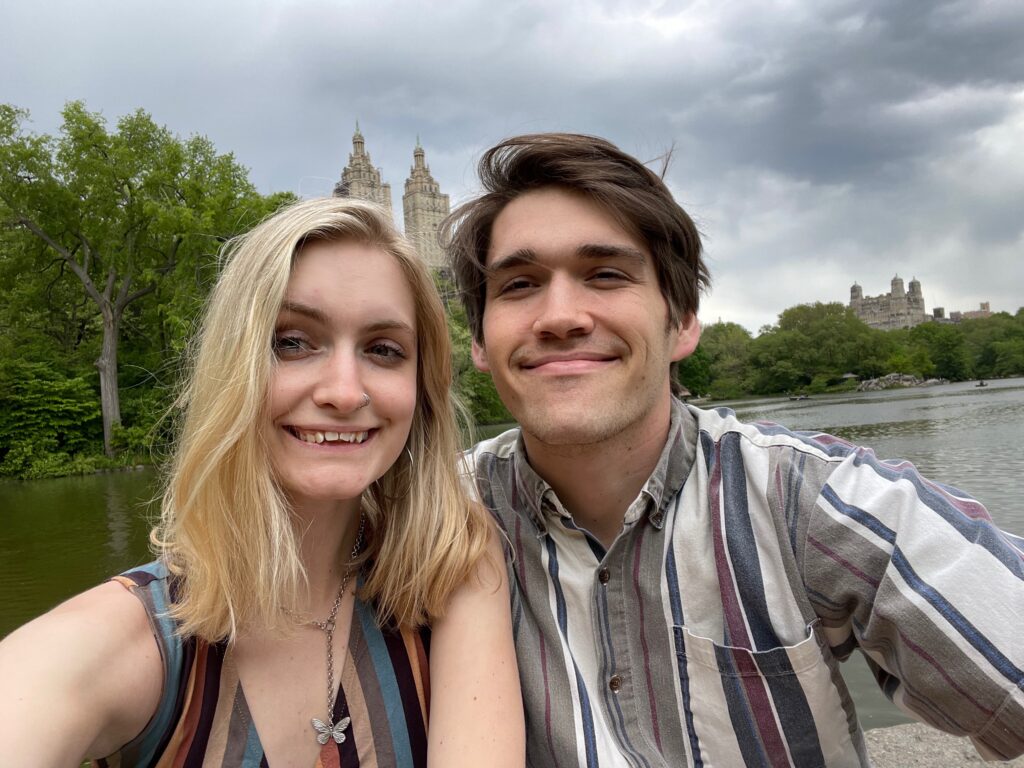 a couple smiling by the water in Central Park 
