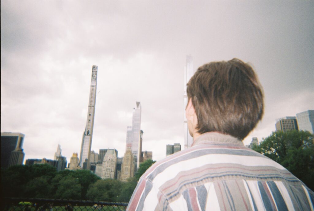 back of a boy's head with New York City skyline in the background