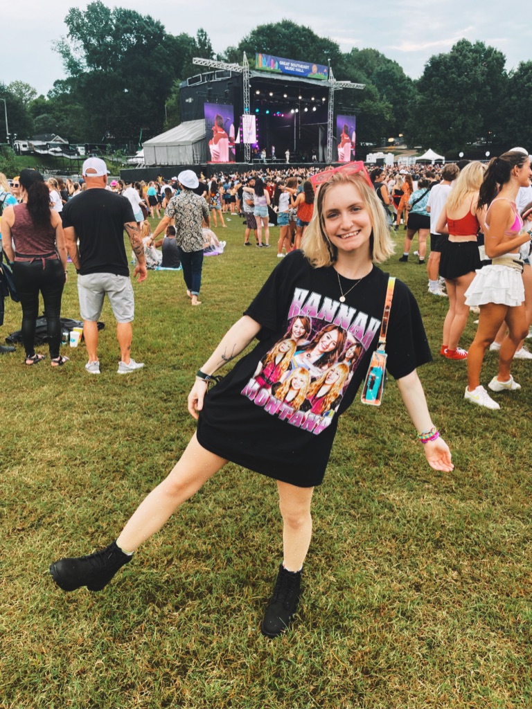 girl at music festival wearing Hannah Montana shirt