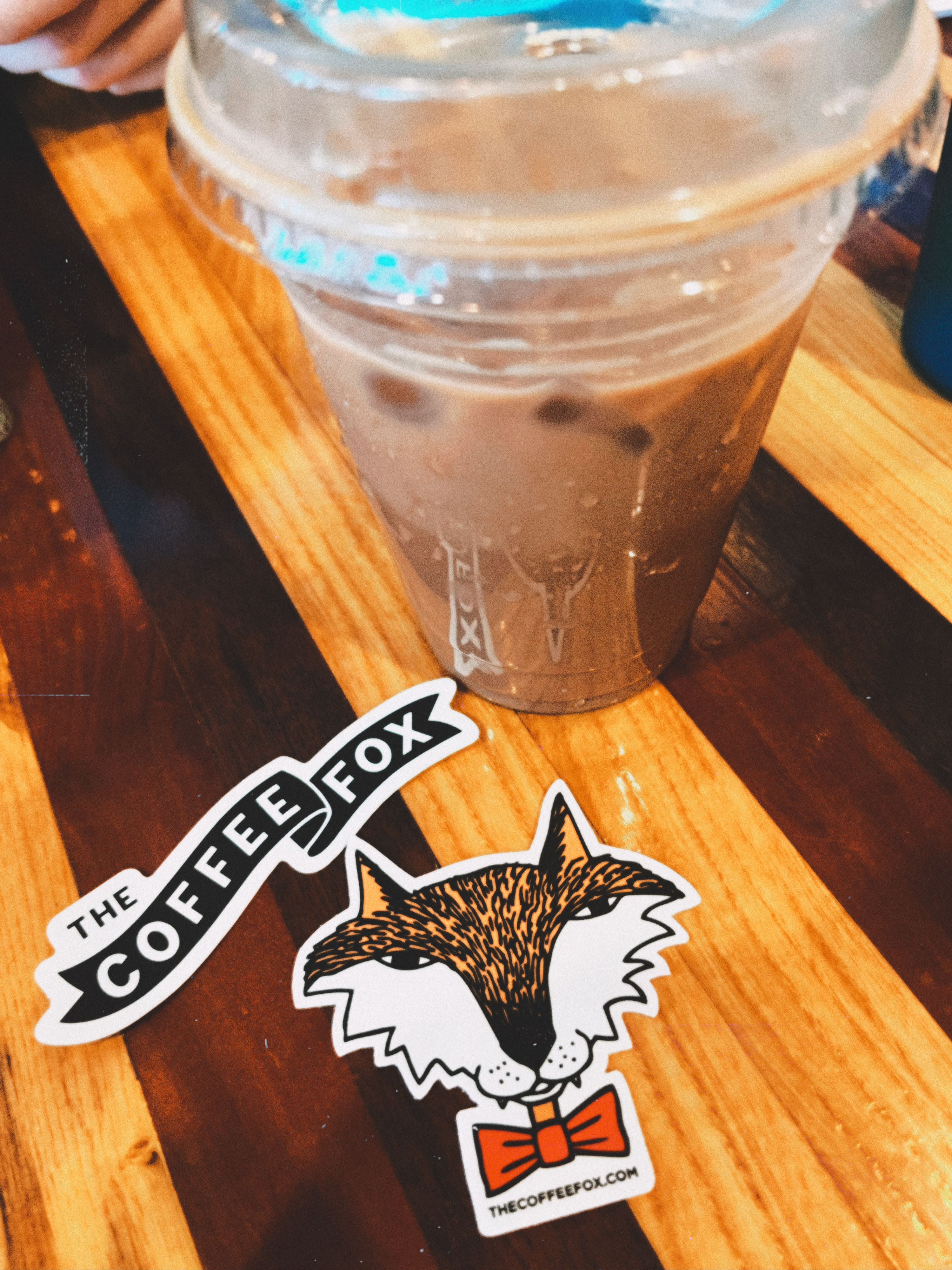 cup of iced coffee and two Coffee Fox stickers 