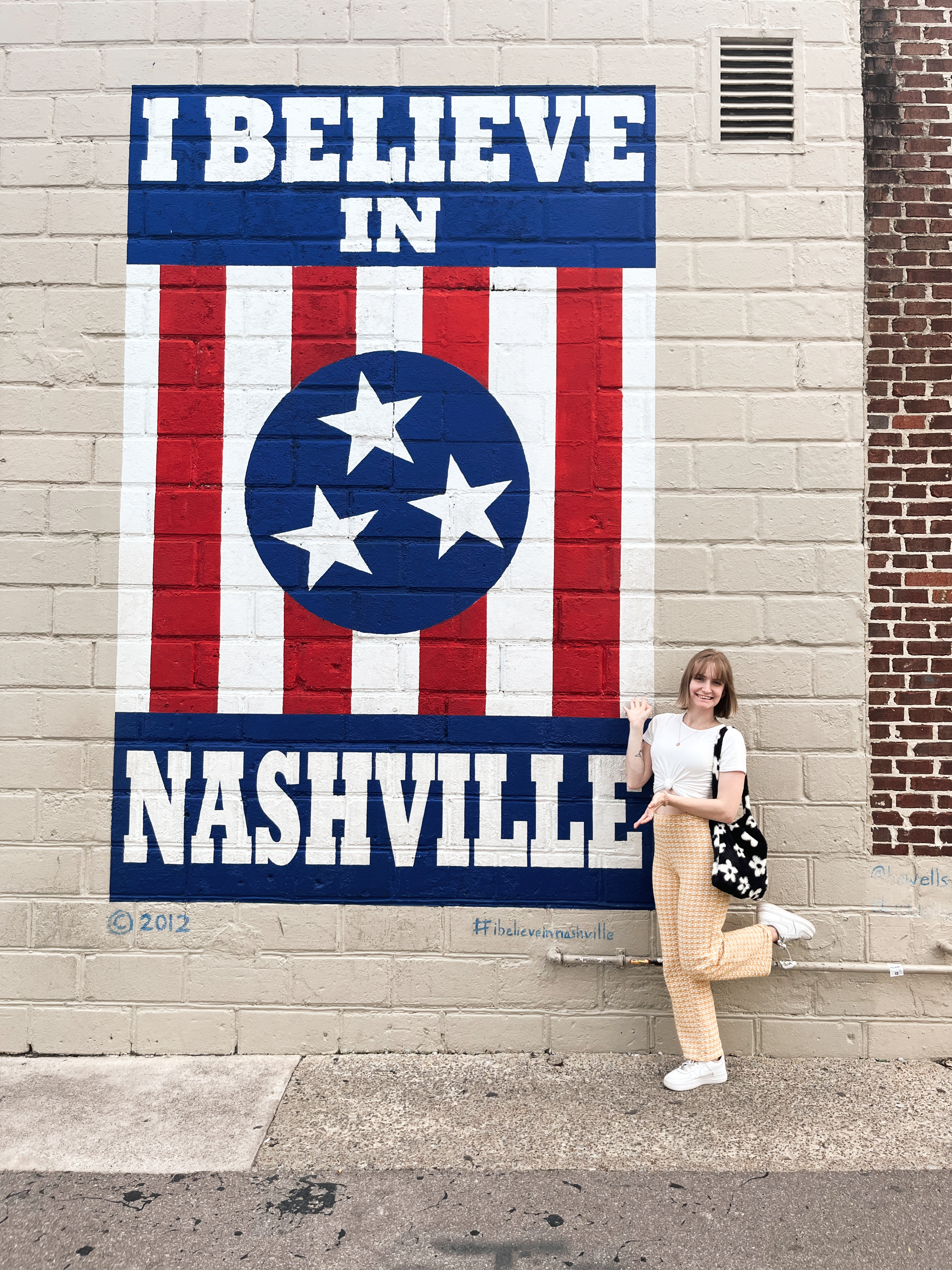 girl posing next to I Believe in Nasvhille mural 