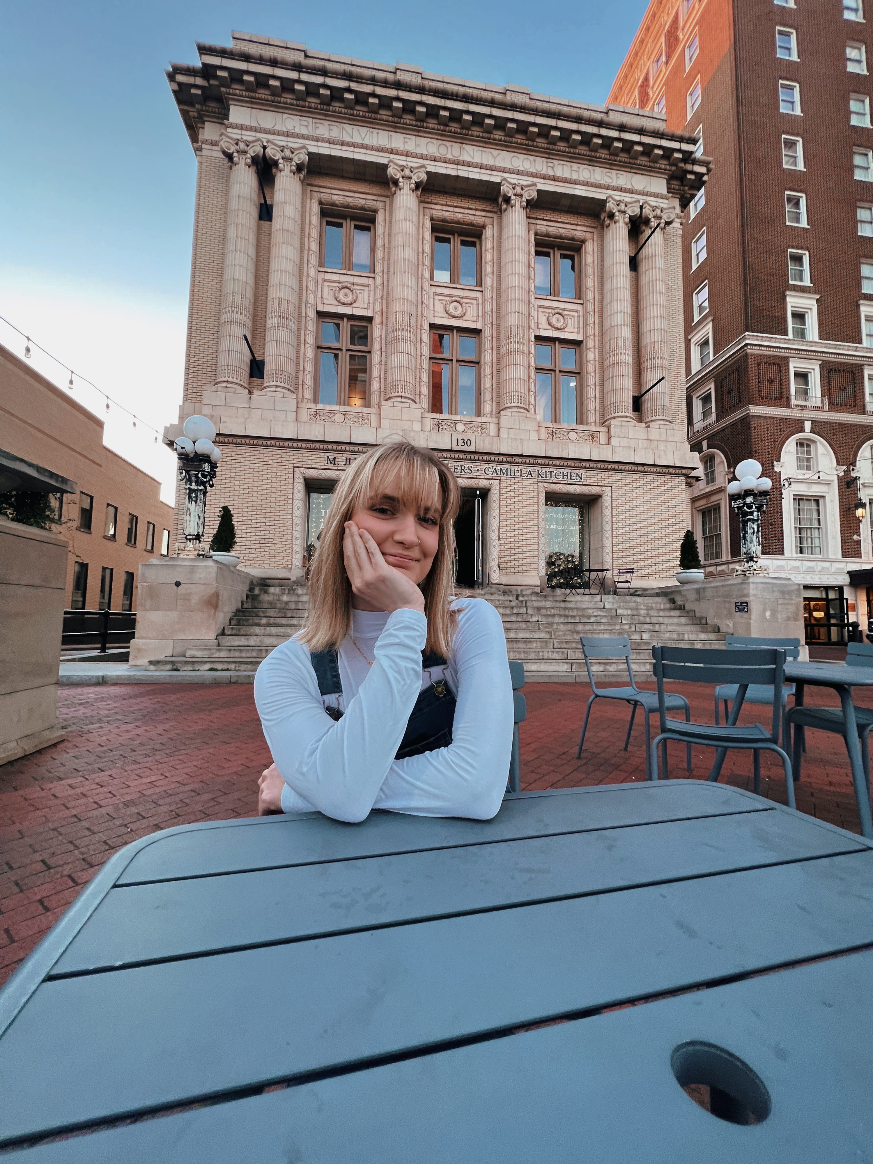 Me posed at a table infront of M.Judson Booksellers in Greenville, South Carolina