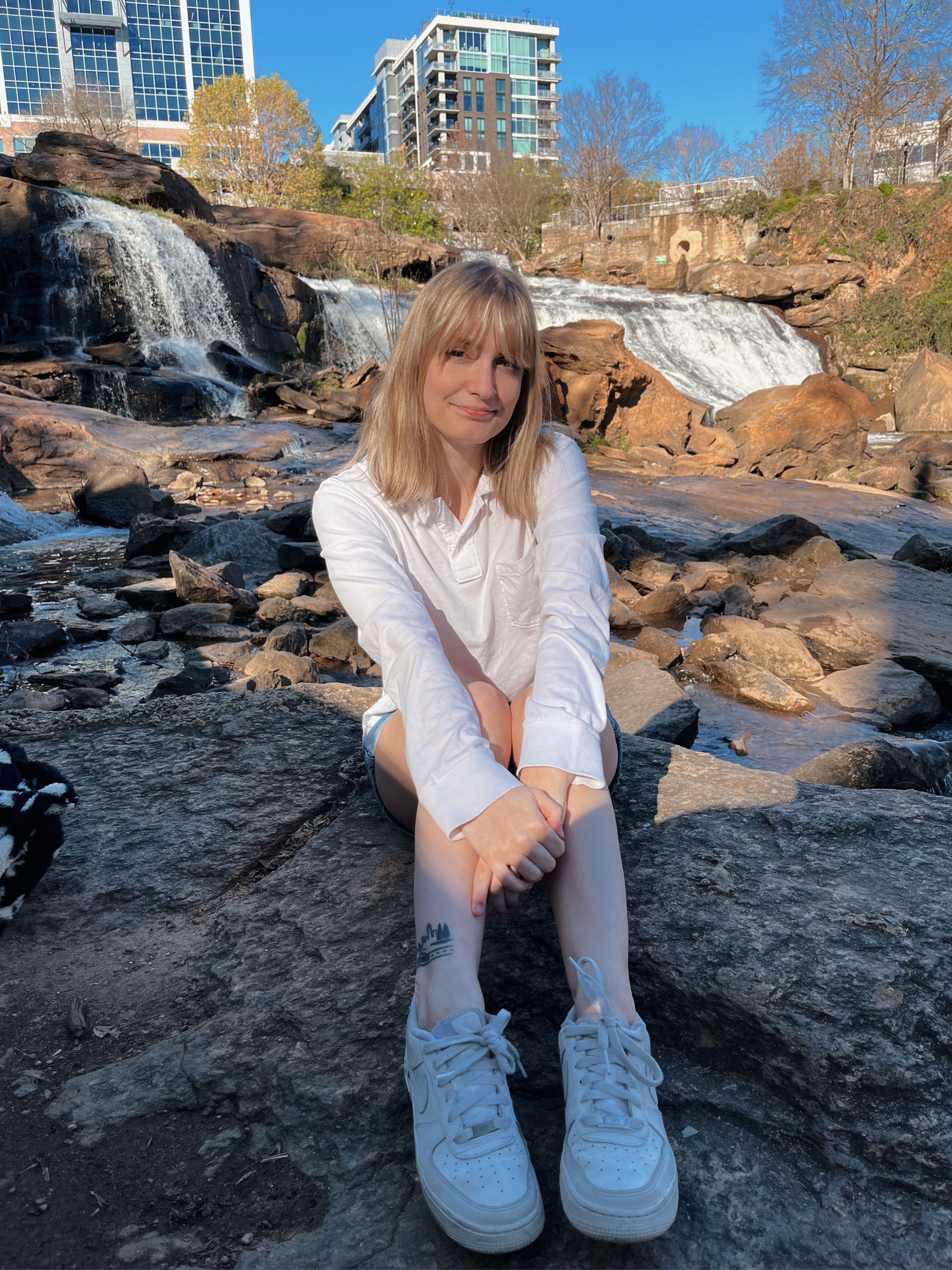 Me sitting in front of the waterfalls at Falls Park On The Reedy in Greenville