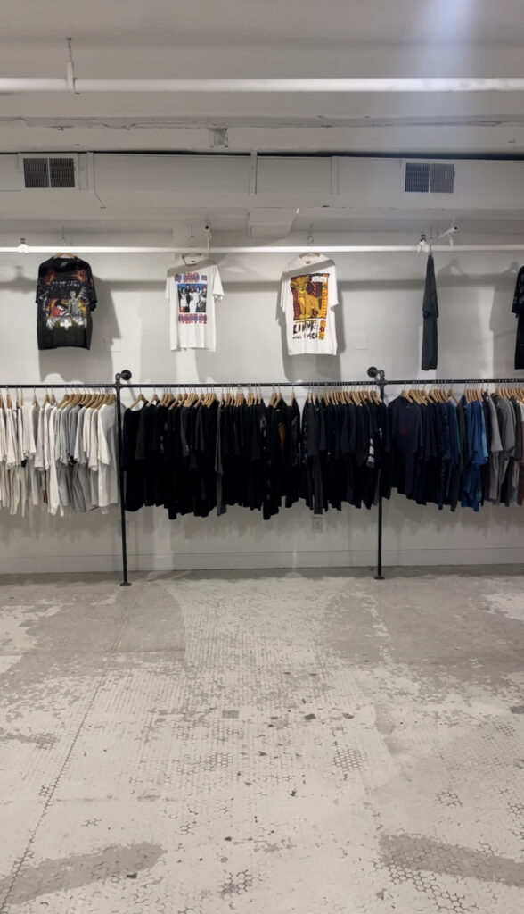 the inside of  Old Skool Outfitter in Greenville, South Carolina (white walls with white and black tshirts) 