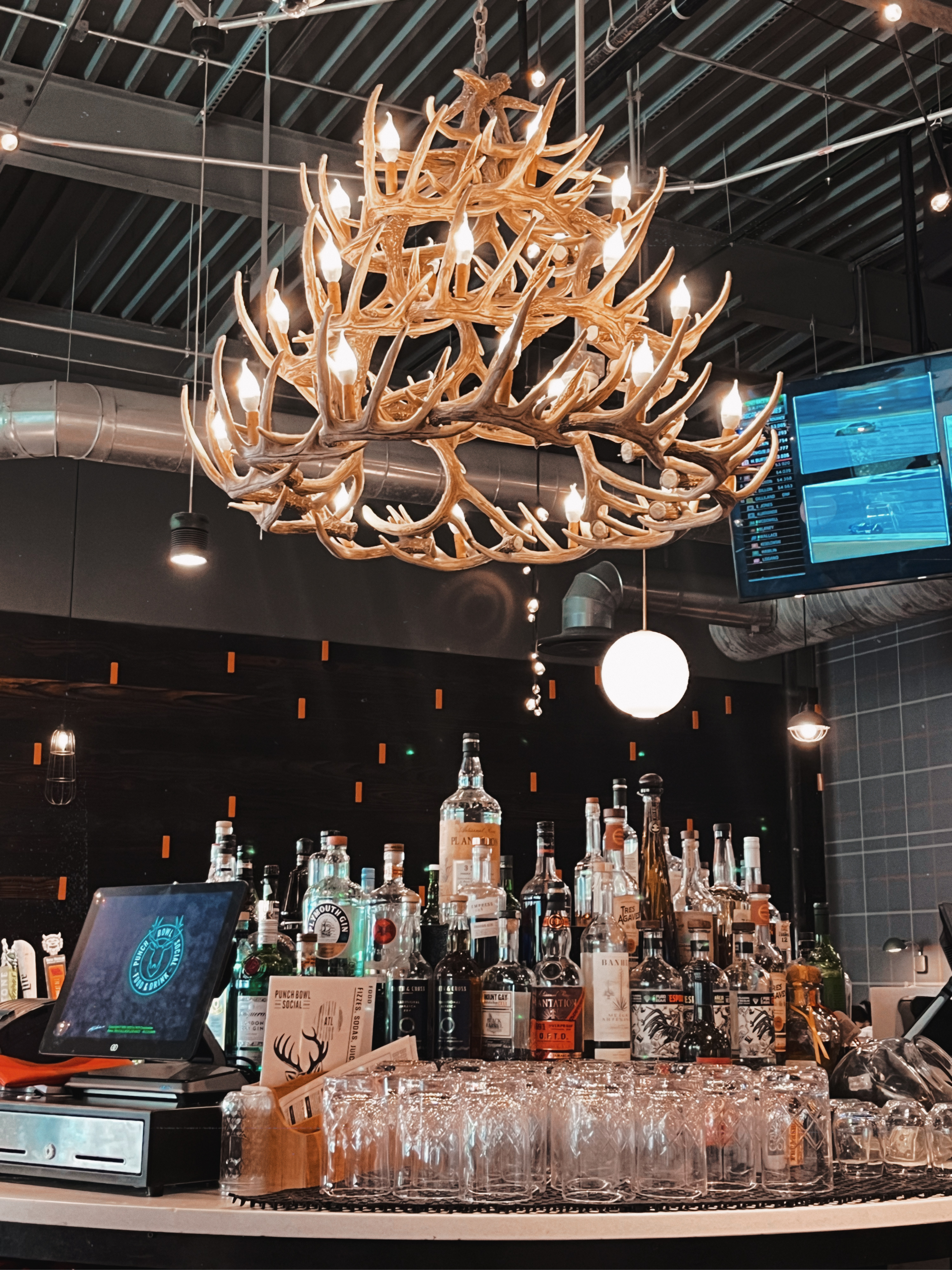 the bar at Punchbowl Social, with a unique deer antler chandelier 