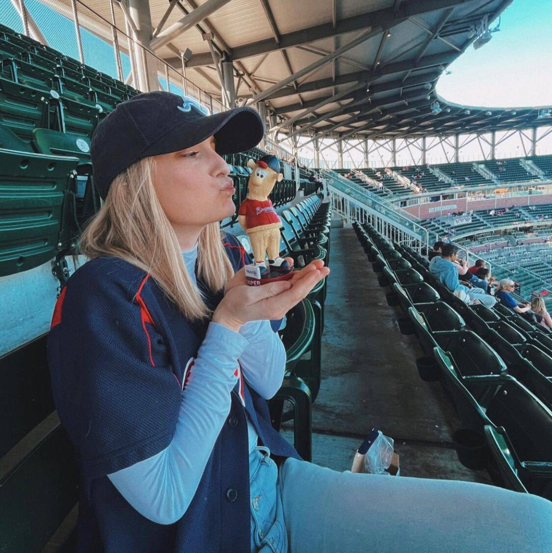 me pretending to kiss my Blooper bobblehead. Blooper is the Atlanta Braves mascot