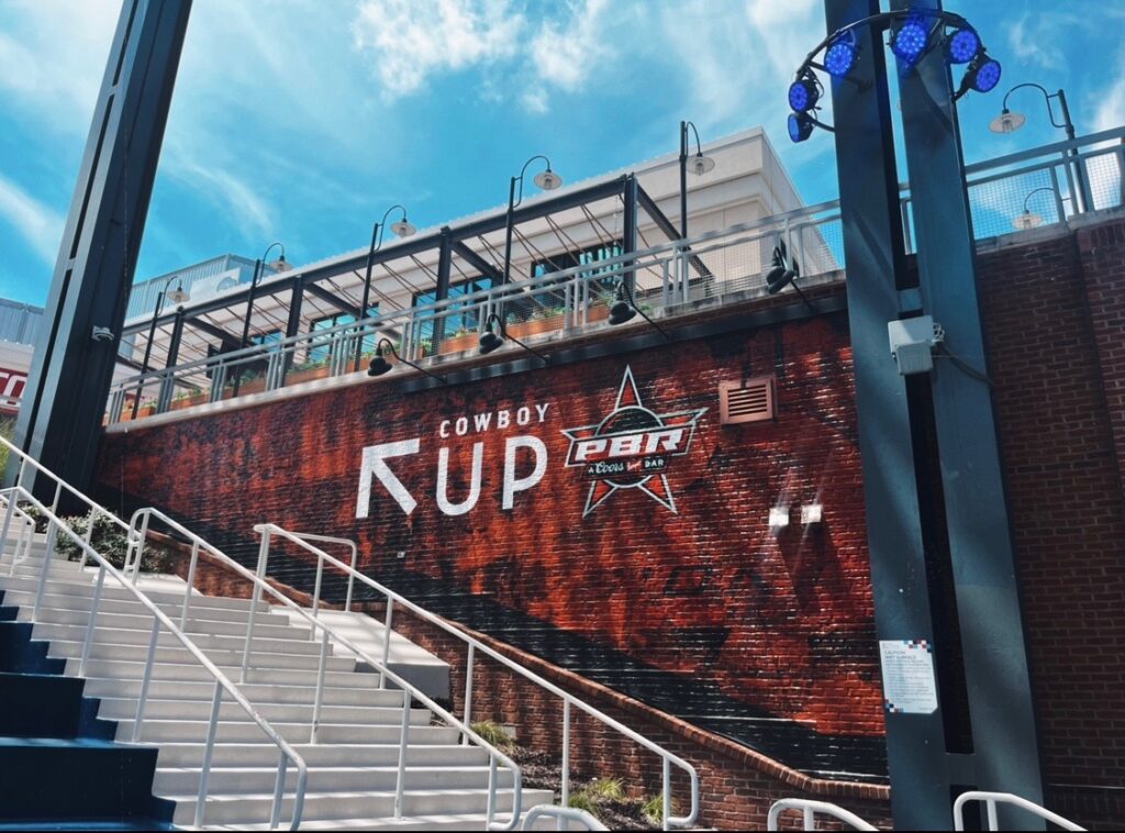 the stairs leading up to PBR, which feature and up arrow and the words "Cowboy Up"