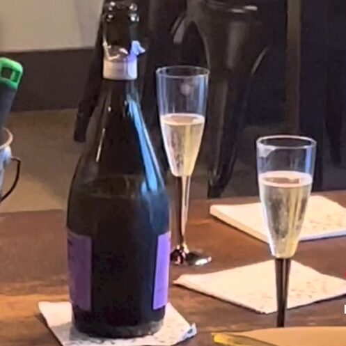 a bottle of champagne and two champagne flutes 