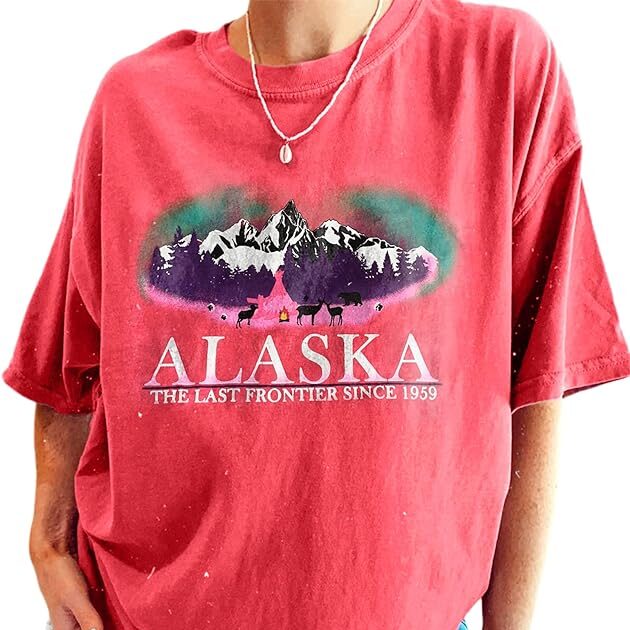 Women's Pink Alaska Graphic Tee of mountains. It says "Alaska The Last Frontier Since 1959"