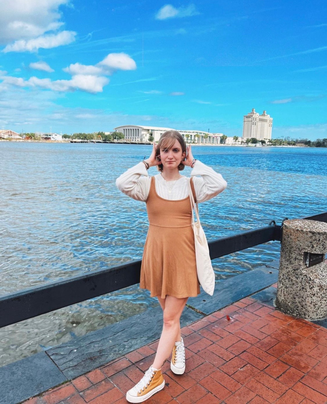girl posed on River Street infront of the river in Savannah Georgia