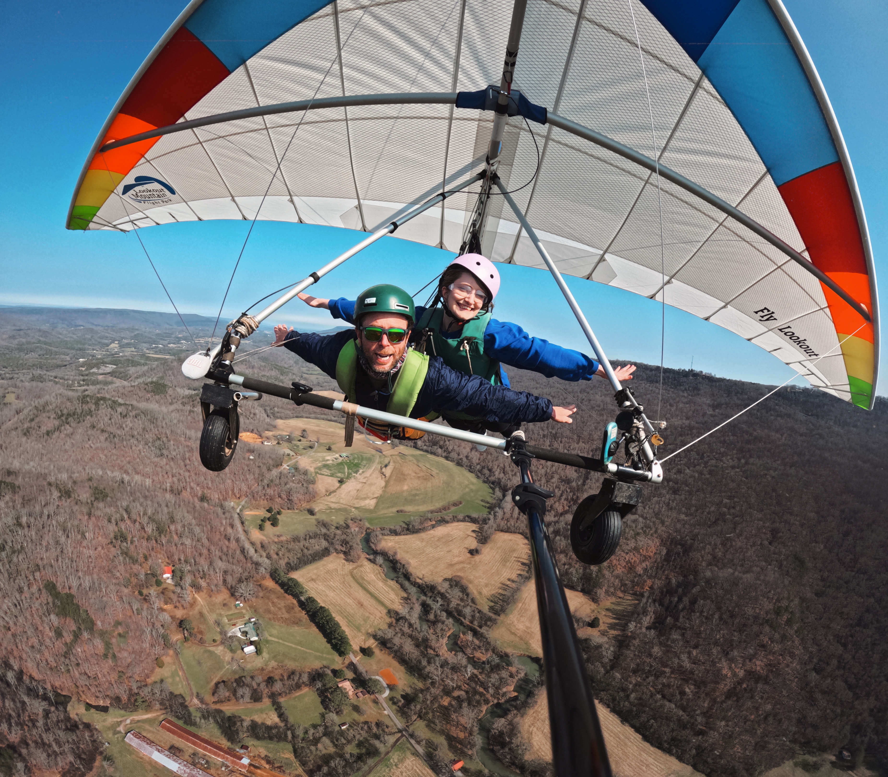 me and an instructor tandem hang gliding with our arms out like birds